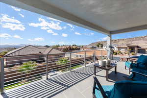 View of patio / terrace with a mountain view, a residential view, and a balcony