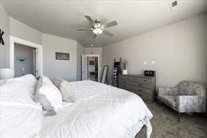 Carpeted bedroom featuring ceiling fan