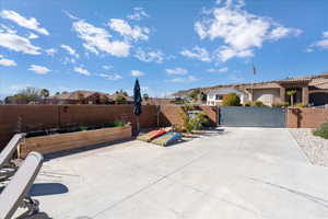 View of patio featuring fence private yard, a gate, and a garden