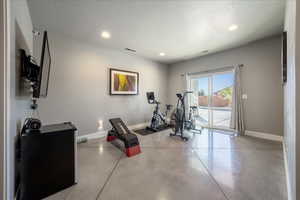 Workout area with recessed lighting, visible vents, and baseboards