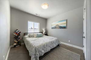 Bedroom with visible vents and baseboards