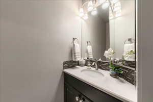 Bathroom featuring backsplash and vanity