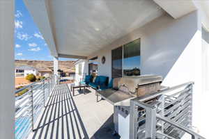 View of patio with a balcony