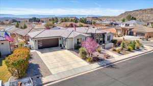 Ranch-style house featuring driveway, a garage, a residential view, and a mountain view