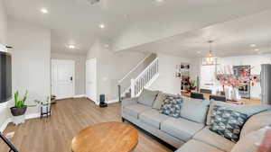 Living room featuring light hardwood / wood-style flooring and lofted ceiling