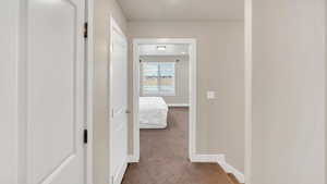 Hallway with light colored carpet