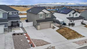 View of front of house featuring a mountain view and a garage