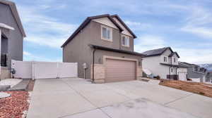 View of side of property with a garage