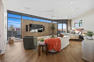 Bedroom featuring light wood-style floors, recessed lighting, and floor to ceiling windows