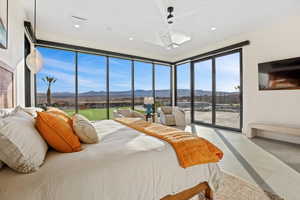 Bedroom featuring access to exterior, recessed lighting, ceiling fan, and light tile patterned floors