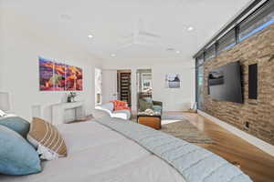 Bedroom featuring baseboards, light wood finished floors, and recessed lighting