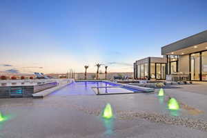 View of swimming pool with a fenced in pool, a patio, and a hot tub