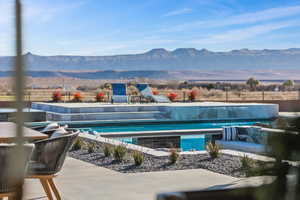 View of swimming pool featuring a mountain view, a swimming pool, and a patio