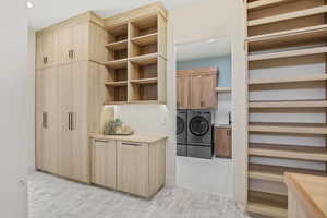 Interior space with a sink, light wood finished floors, and washing machine and dryer