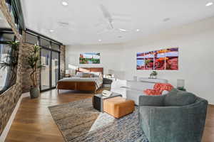 Bedroom featuring ceiling fan, wood finished floors, and recessed lighting