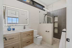 Full bath with toilet, walk in shower, and vanity