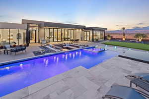 View of pool featuring an infinity pool, a patio area, and a hot tub