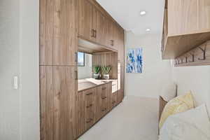 Interior space featuring light tile patterned flooring, baseboards, light countertops, and recessed lighting