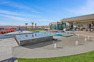 View of pool featuring a fenced in pool, a patio, and an in ground hot tub