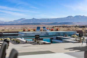 Outdoor pool with a mountain view and a patio