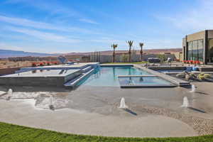 View of pool featuring a patio, fence, a mountain view, and a fenced in pool