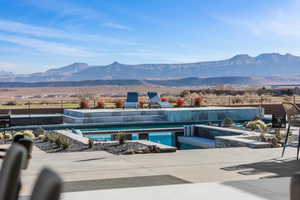 Outdoor pool with a patio and a mountain view