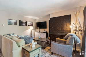 Living room with a textured ceiling and baseboards