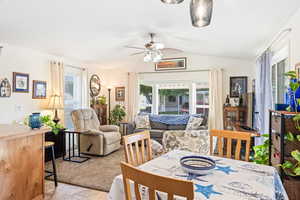 Dining space featuring lofted ceiling and a ceiling fan