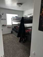 Carpeted bedroom featuring a textured ceiling and baseboards