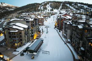 Snowy aerial view with a residential view and a mountain view