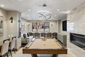 Rec room with recessed lighting, billiards, and a high end fireplace