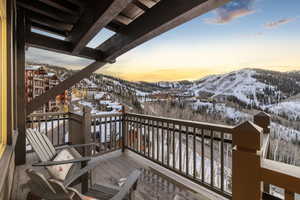 Snow covered deck with a mountain view