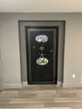 Details with wood finished floors and baseboards