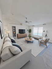 Family room featuring ceiling fan, vaulted ceiling, and carpet