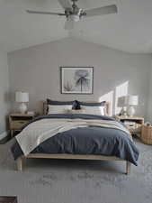 Bedroom with lofted ceiling, carpet floors, and ceiling fan