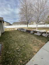 View of yard featuring fence