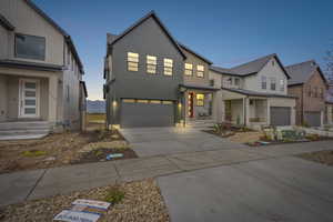 View of front of property featuring driveway and an attached garage