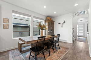 Dining room featuring hardwood / wood-style floors, recessed lighting, visible vents, and baseboards