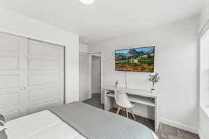 Carpeted bedroom featuring a closet and baseboards