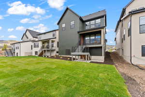 Rear view of house featuring stairs, a mountain view, and a lawn