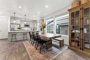 Dining space with recessed lighting and hardwood / wood-style floors