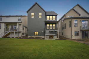 Back of house featuring a yard and stairway