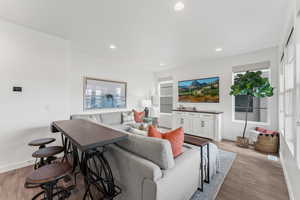 Living room with baseboards, hardwood / wood-style floors, and recessed lighting