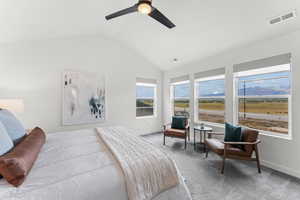 Bedroom with carpet flooring, visible vents, baseboards, vaulted ceiling, and a ceiling fan