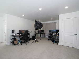 Office featuring a textured ceiling, carpet, baseboards, and recessed lighting