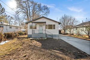 Bungalow-style house featuring fence