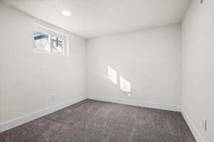 Empty room with carpet floors and baseboards