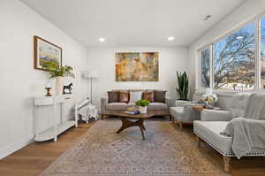 Sitting room with recessed lighting, wood finished floors, visible vents, and baseboards