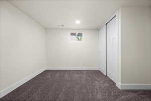 Unfurnished bedroom featuring carpet, a closet, visible vents, and baseboards