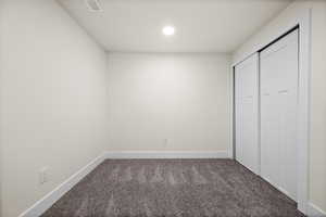 Unfurnished bedroom with recessed lighting, carpet flooring, visible vents, and baseboards